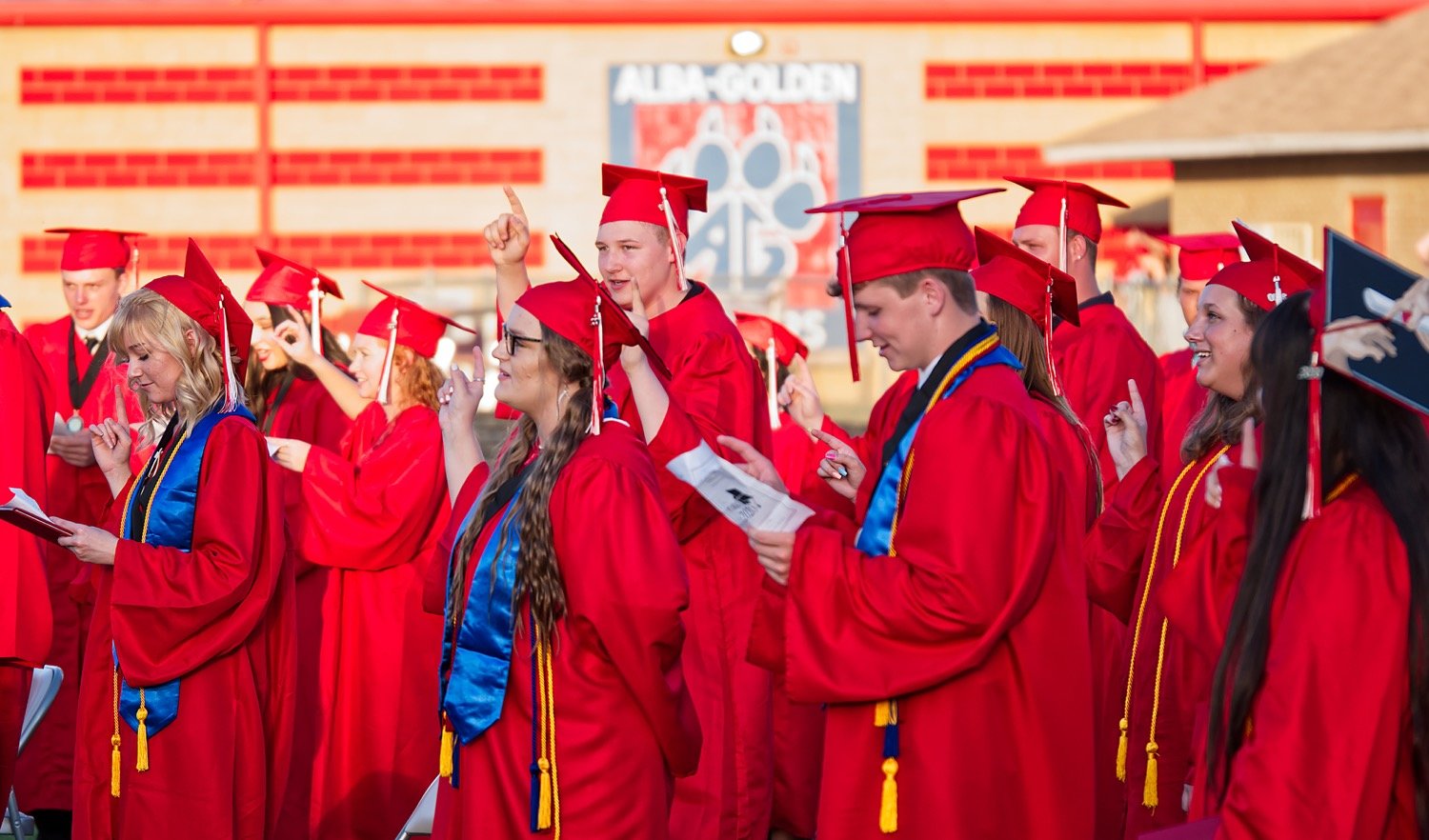 Alba-Golden grads sing the alma mater one last time at last Thursday’s high school graduation at Panther Stadium.